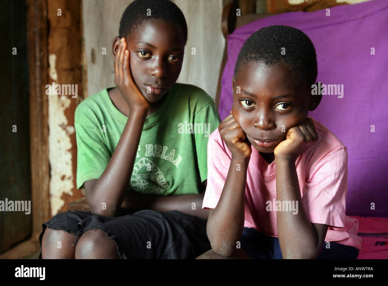 HIV/AIDS orphans in a village in Tanzania ho have lost her mother looking sadly into the camera. Stock Photo