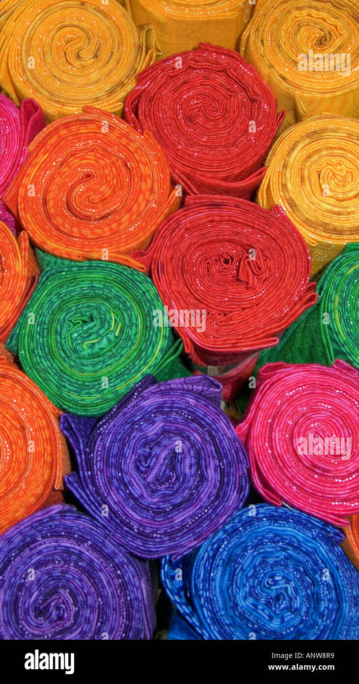 Rolls of colourful cloth for sale in a haberdashery and fabric store Stock Photo