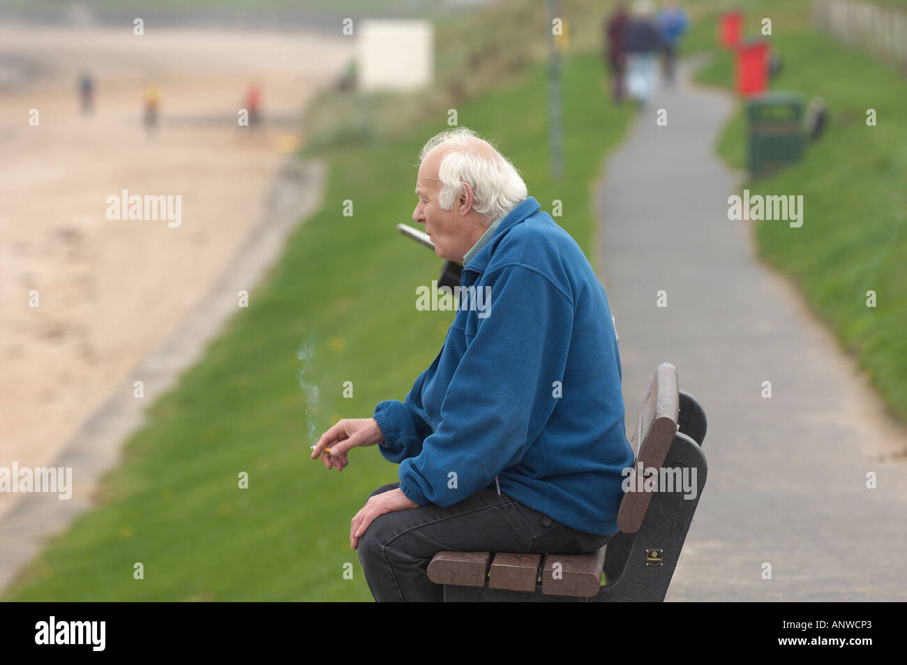 Old man smoking a cigarette Stock Photo