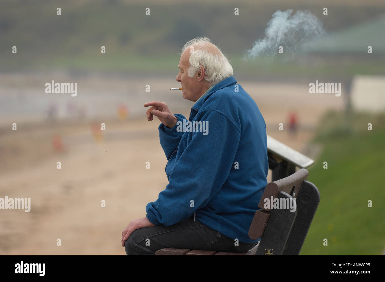 Old man smoking a cigarette with pleasure Stock Photo