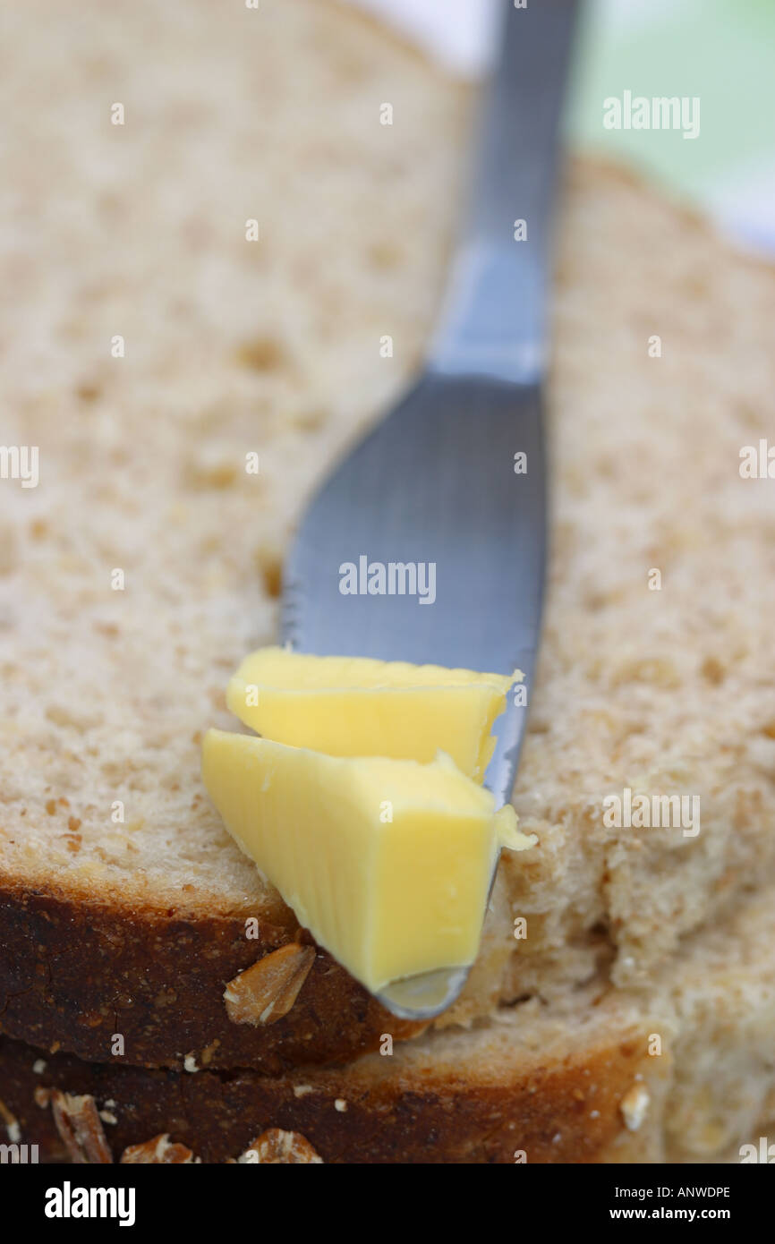 Butter on knife with wholemeal bread Stock Photo