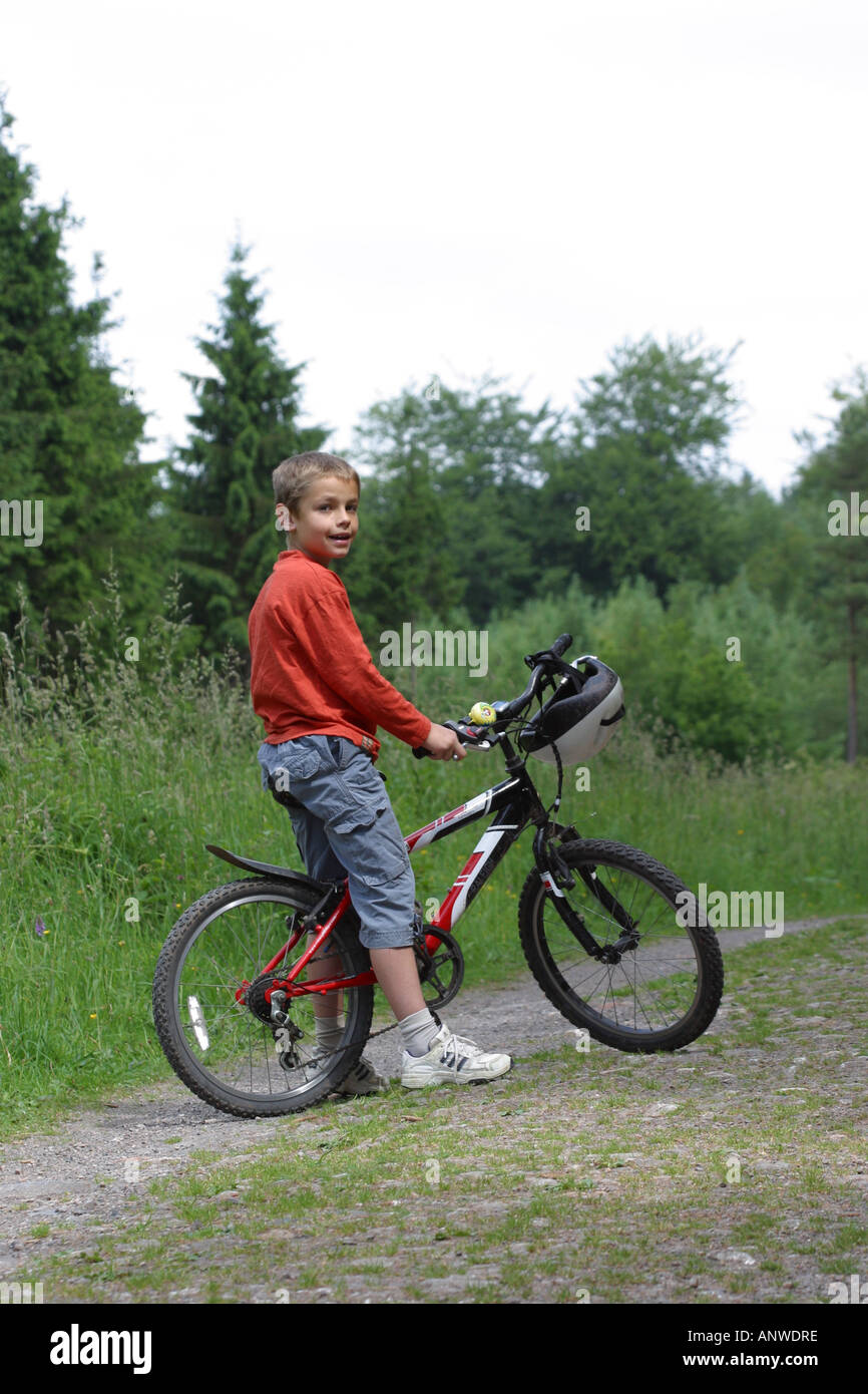 Young boy aged 10 years old on bike bicycle on forest path track outdoor exercise activity Stock Photo Alamy