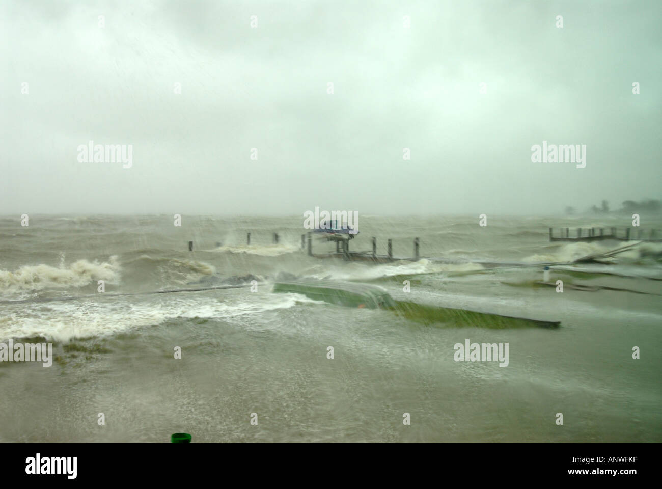 Nature Weather tropical storm hurricane waves crashing over wood piers and seawalls Stock Photo