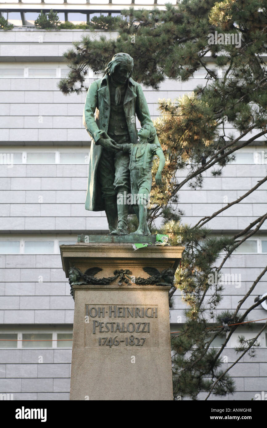 Statue of Pestalozzi in front of the big globus building, Zurich, Switzerland Stock Photo