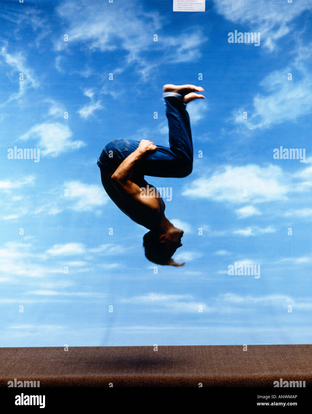 Guy doing a somersault against sky background Stock Photo - Alamy