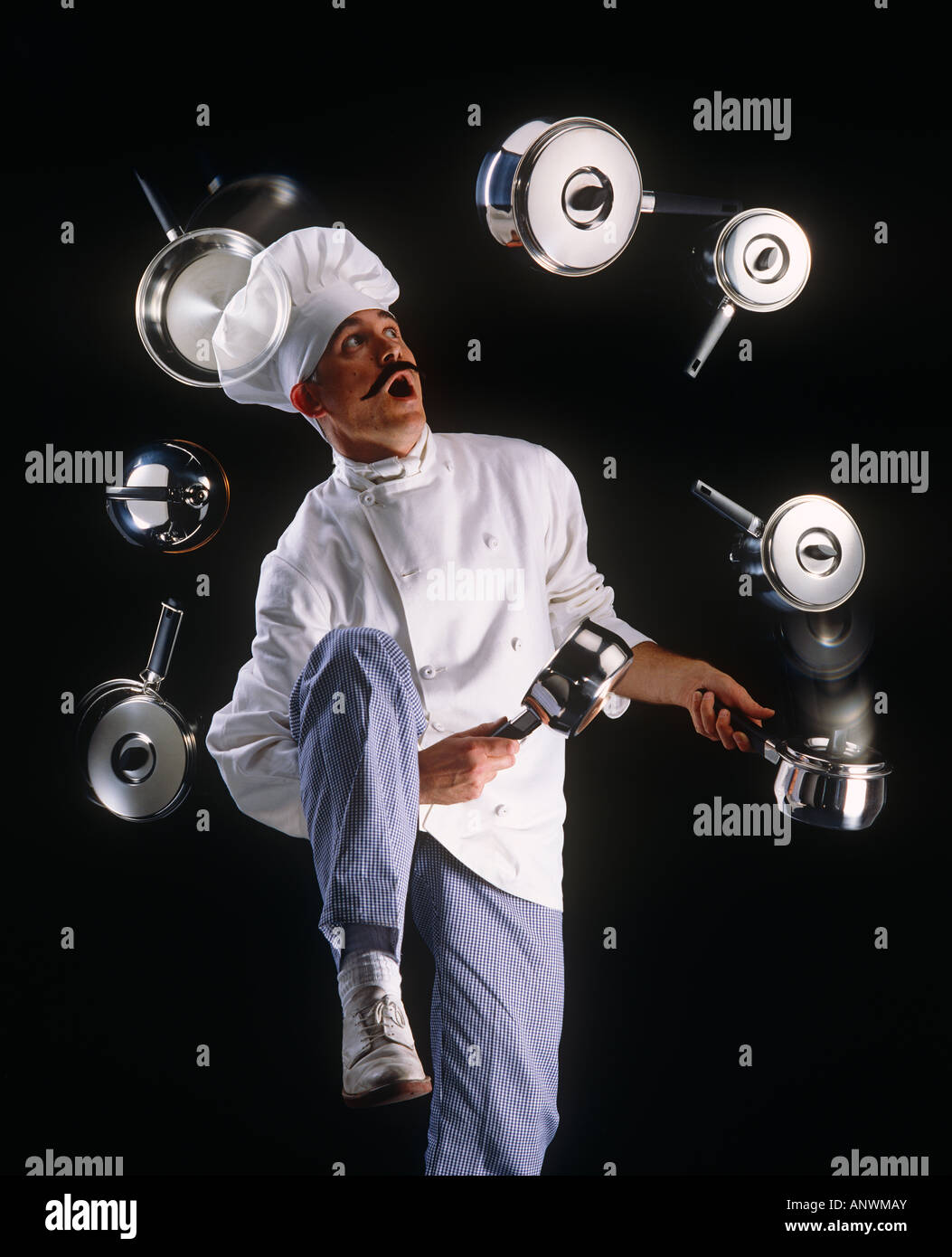Chef juggling saucepans Stock Photo