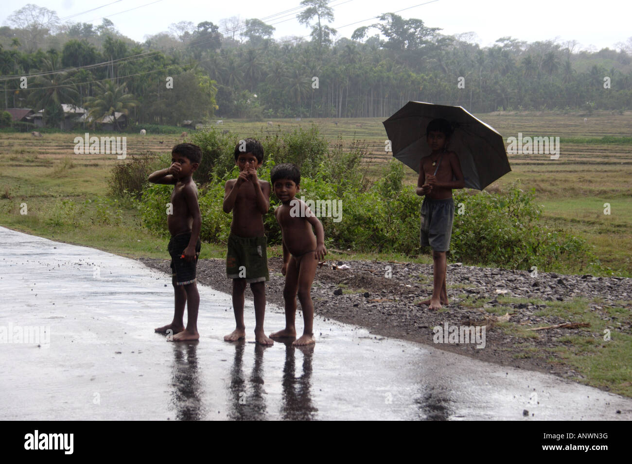 kids playing in the rain Stock Photo - Alamy