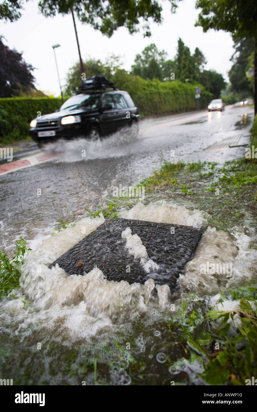 A manhole cover overflowing during floods of 2007, Gloucestershire, UK Stock Photo