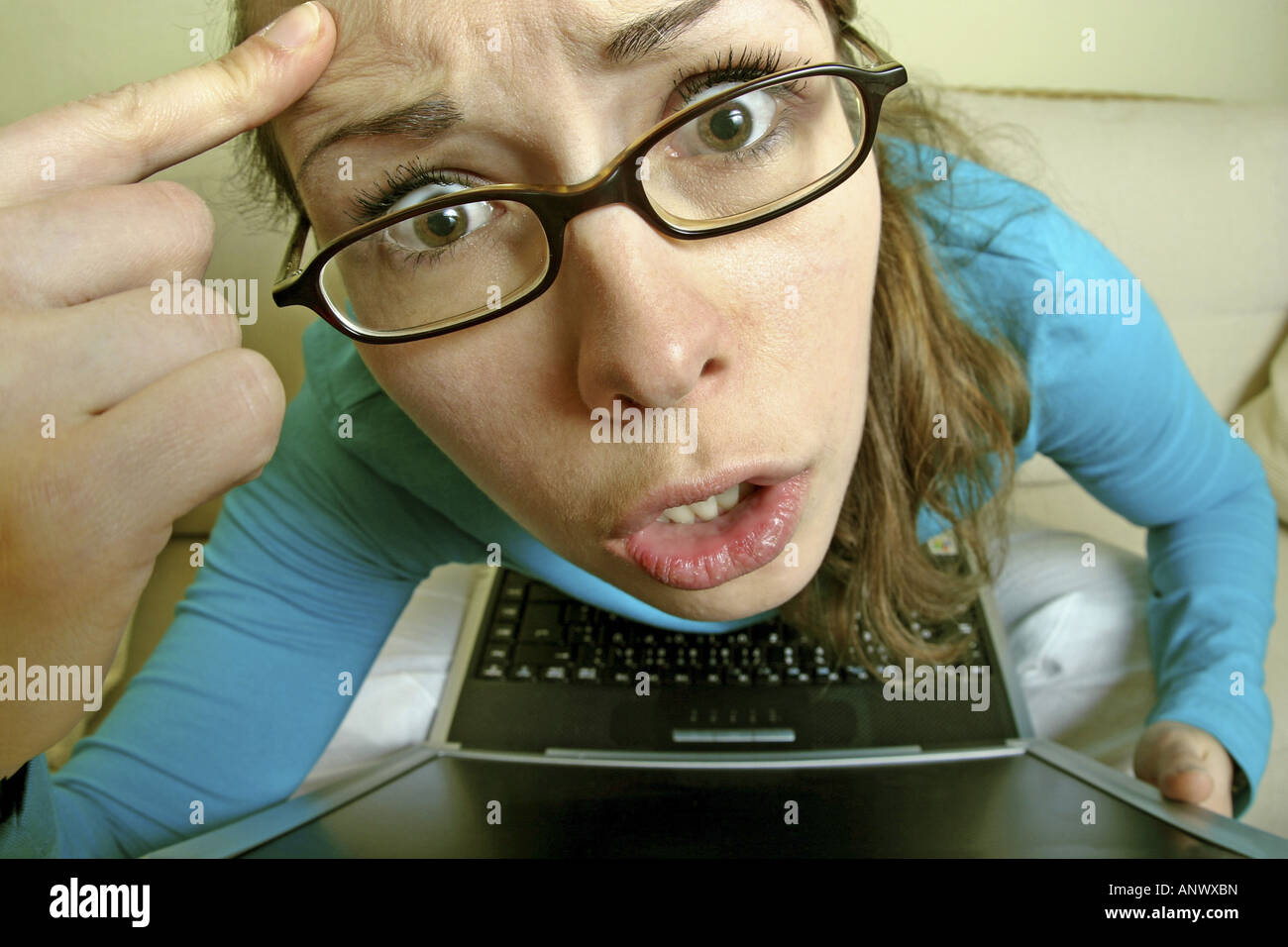 young woman with glasses and notebook give someone the bird Stock Photo
