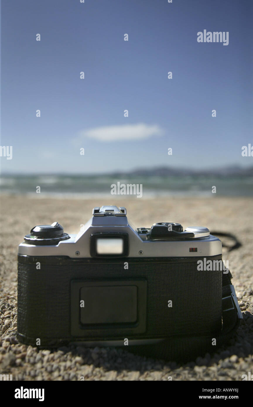 camera lying on the beach Stock Photo