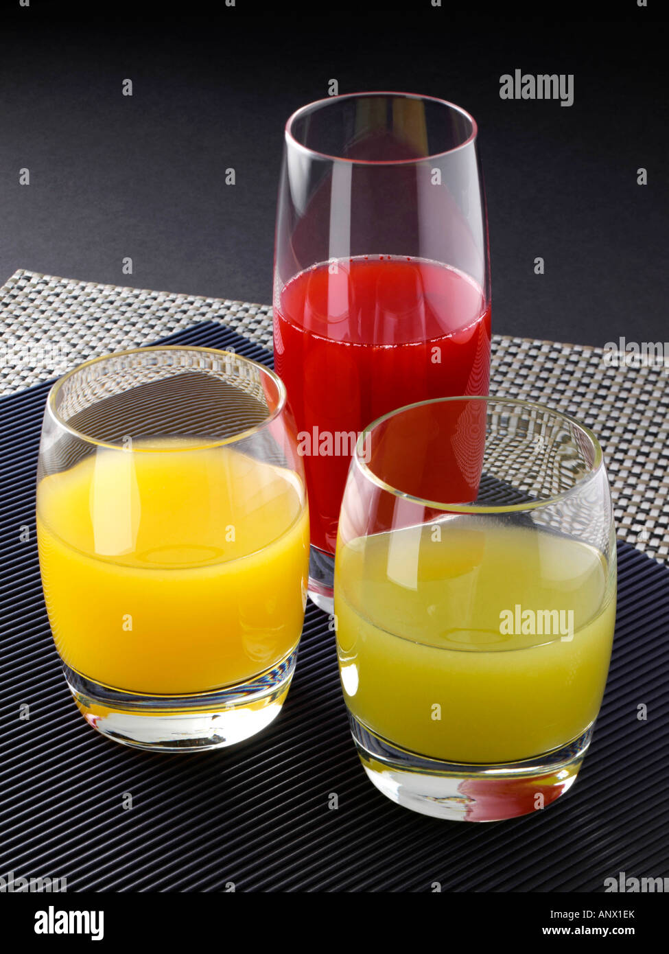 Isolated juices. Glasses of fresh juice and pile of tropical