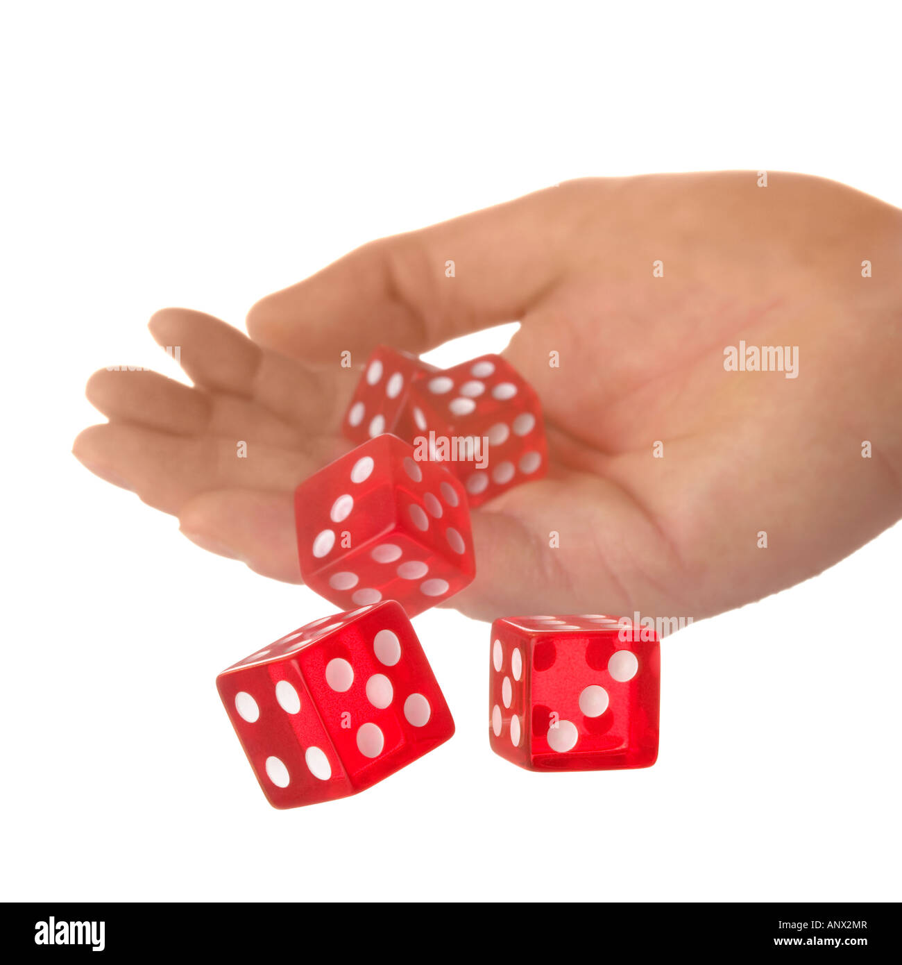 Five red dice being thrown from a hand shallow DOF Stock Photo