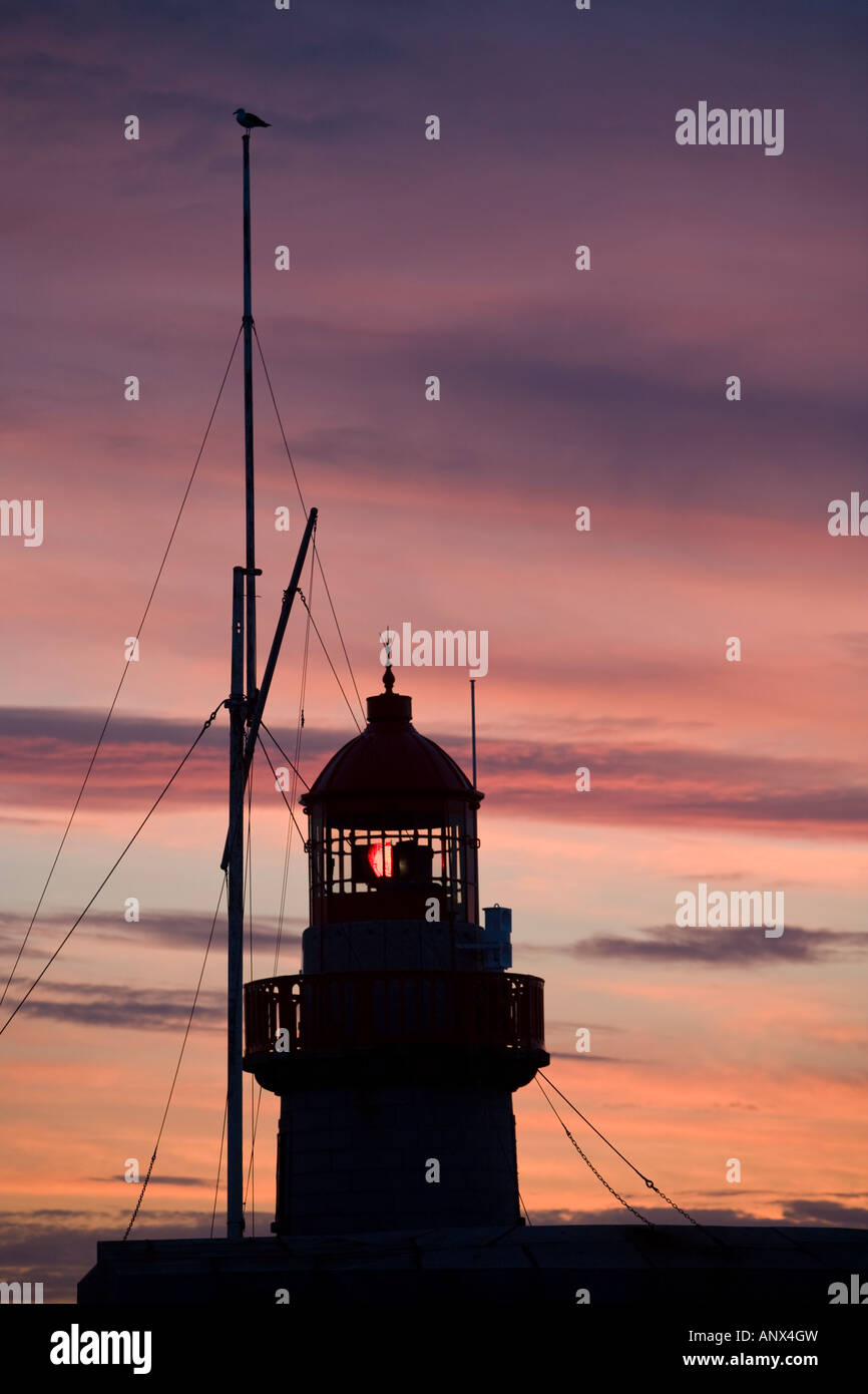 Lighthouse in Dun Loaghaire at sunset Stock Photo
