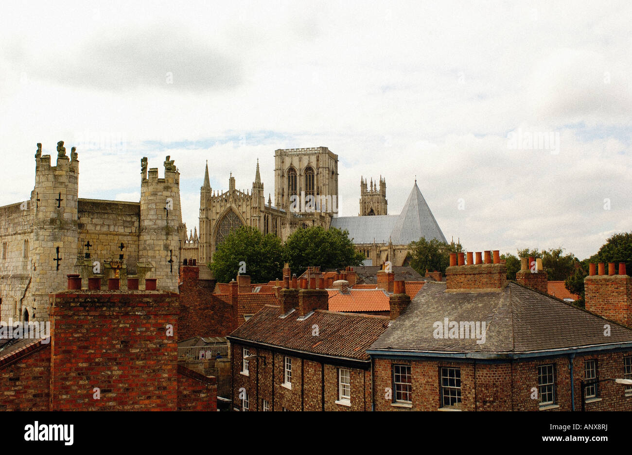 Elevated view of Monk Bar, the Great East Window, and Chapter House of York Minster with Monkgate properties in the foreground. UK Stock Photo
