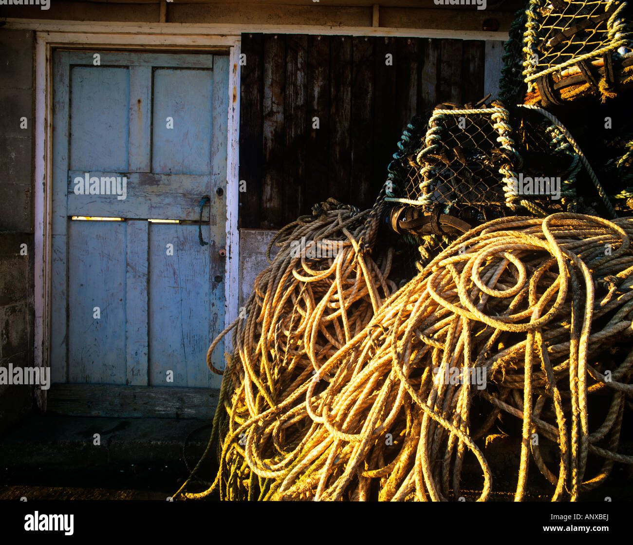 an old fisherman hut with ropes and lobster pots and an old weather