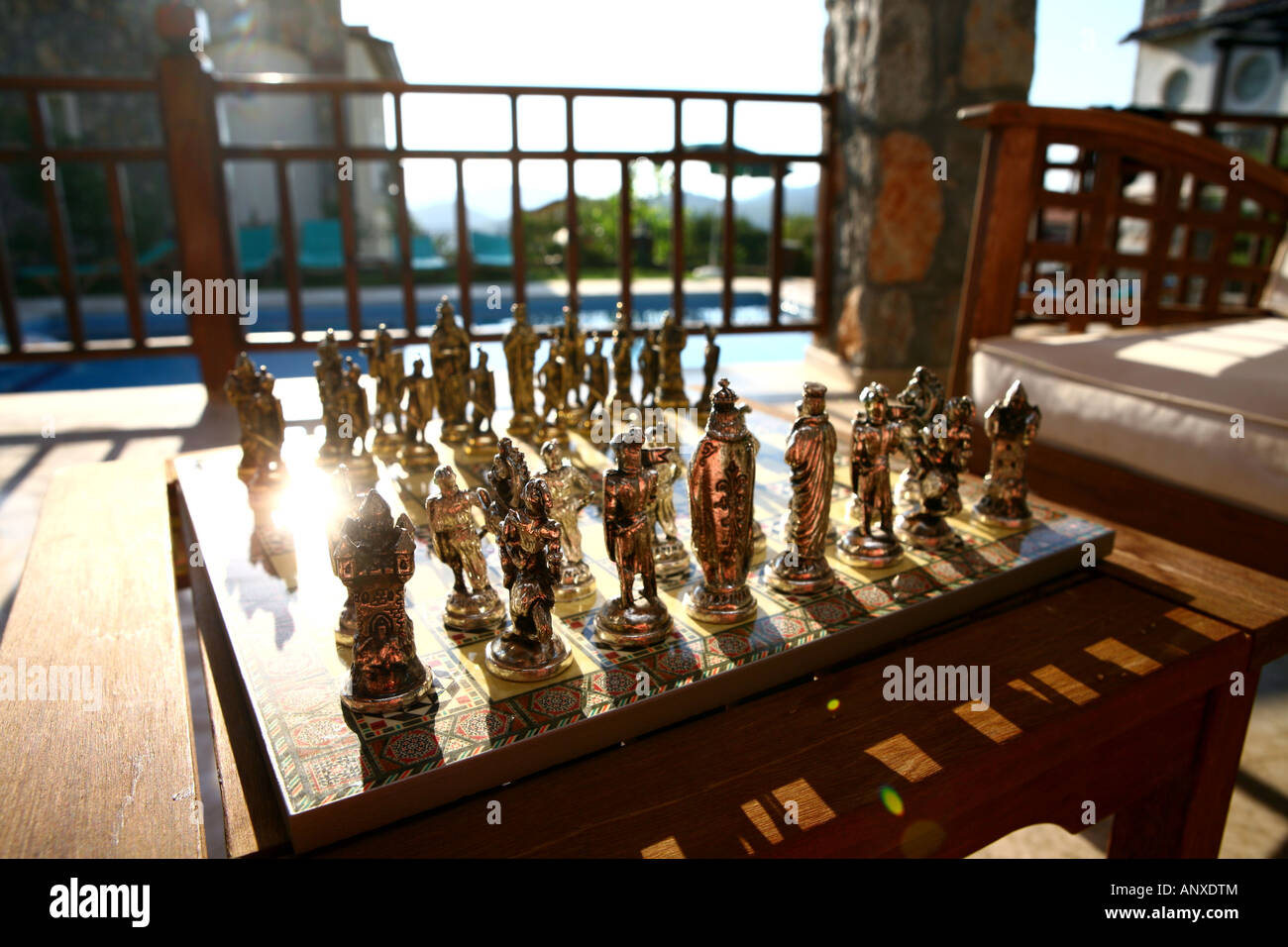 Exotic chess set next to swimming pool at villa in Turkey Stock Photo