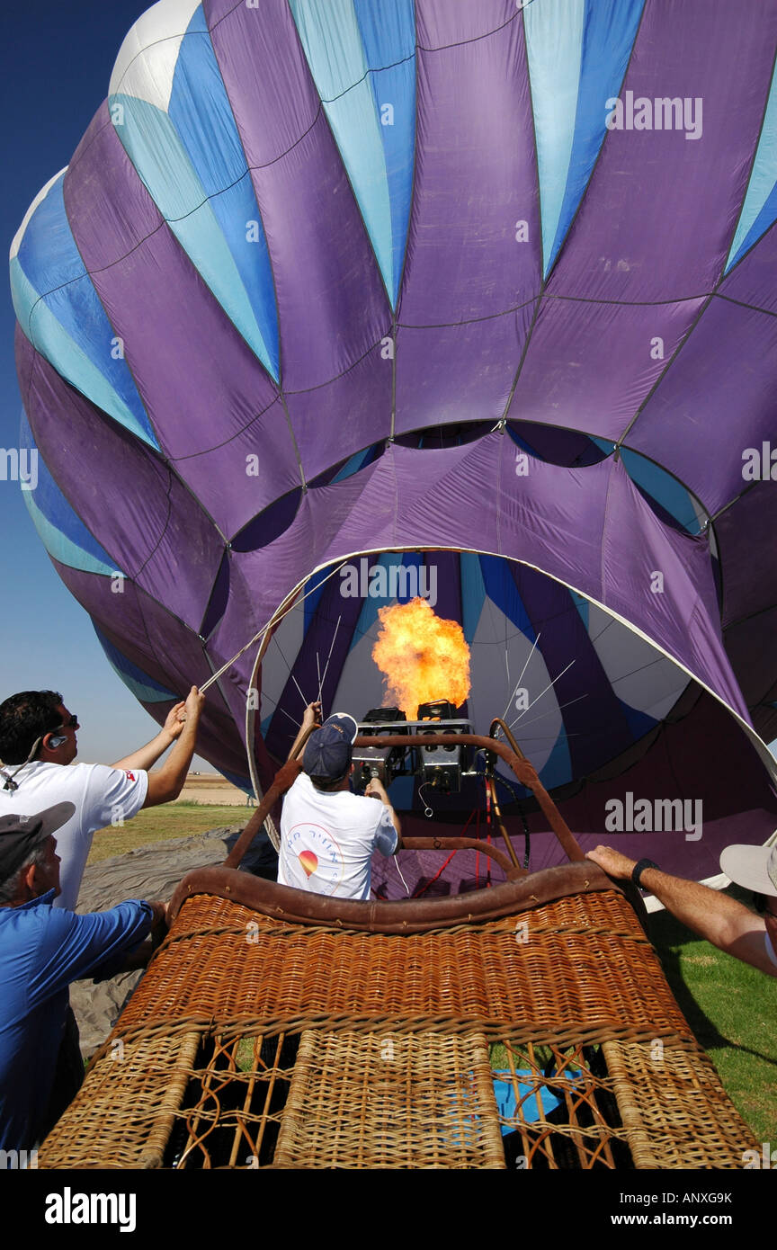 Ground crew preparing a hot air balloon before takeoff Stock Photo
