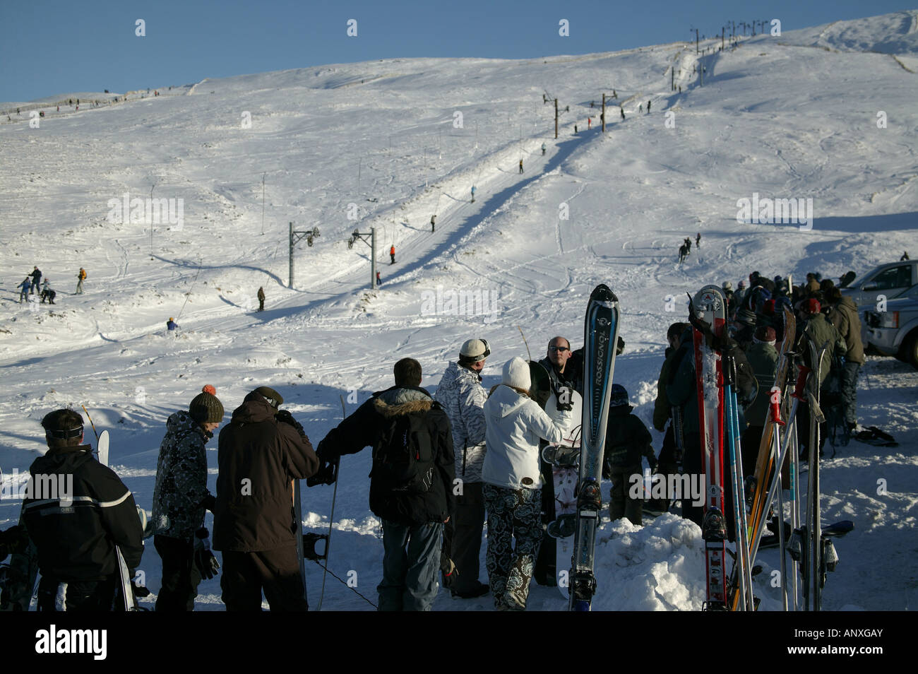 Skiers and snowboarders queuing for chairlift, Cairngorms National Park, Glenshee, Perthshire and Aberdeenshire, Scotland Stock Photo