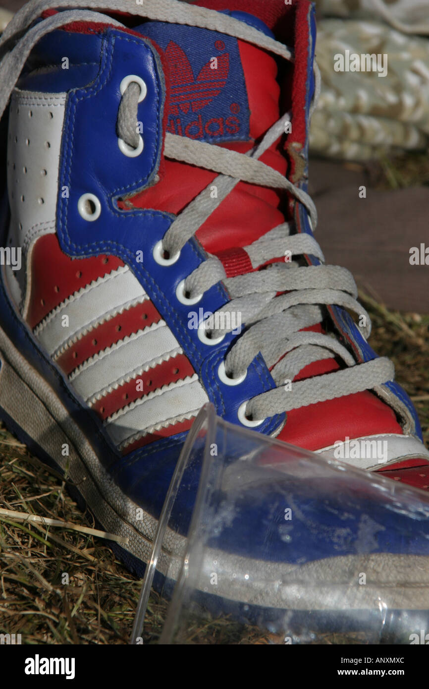 Olds skool Adidas sneakers left in the mud of Glastonbury music festival  Stock Photo - Alamy