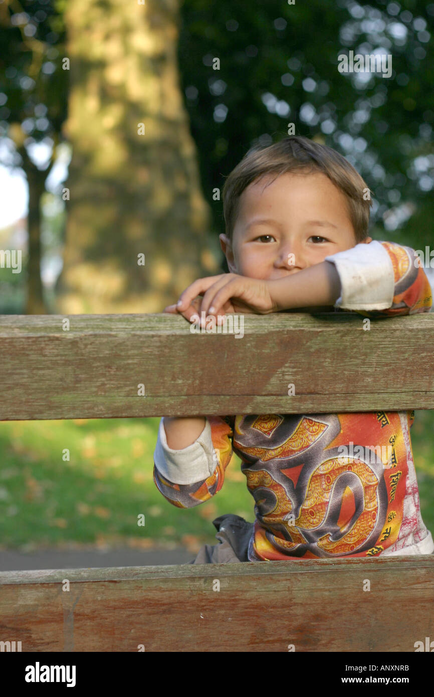 Boy on a park bench Stock Photo - Alamy