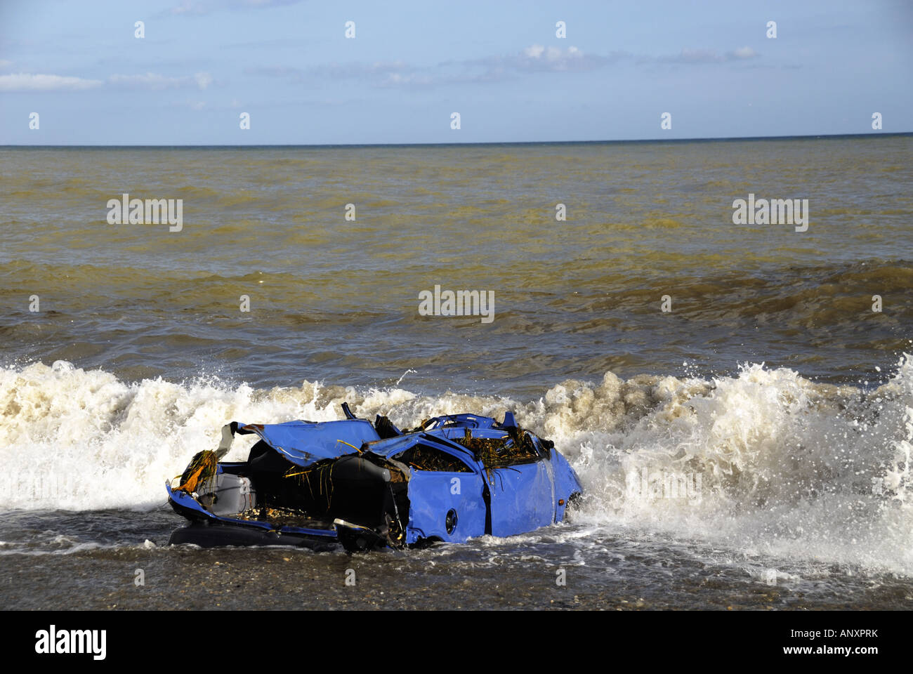 Wrecked blue car in Mediterranean, washed into the sea by storms around Sabinillas, Spain in December 2007 Stock Photo