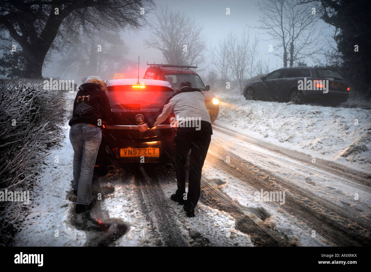 A CAR STUCK IN SNOWY CONDITIONS NEAR WOTTON UNDER EDGE GLOUCESTERSHIRE UK Stock Photo