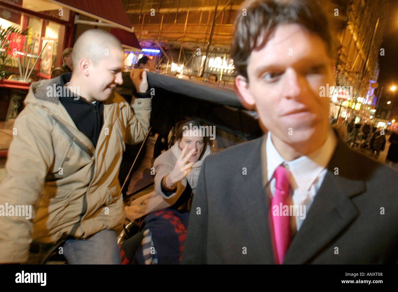 couple arguing in the west end on a night out with a rickshaw Stock Photo