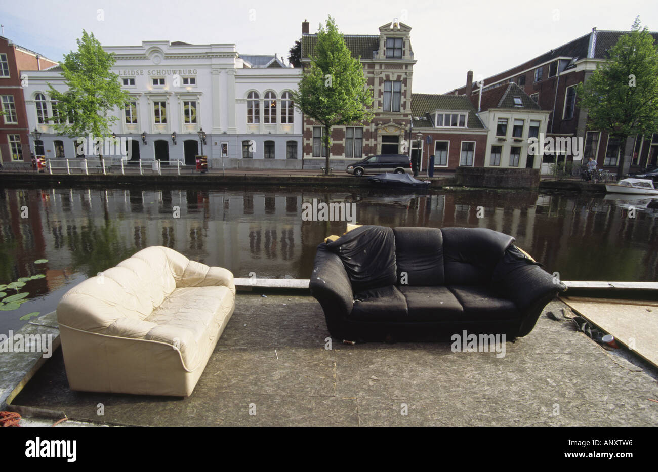 Two battered sofas on the bank of Mare River. Leiden. Leyden. Netherlands. Stock Photo