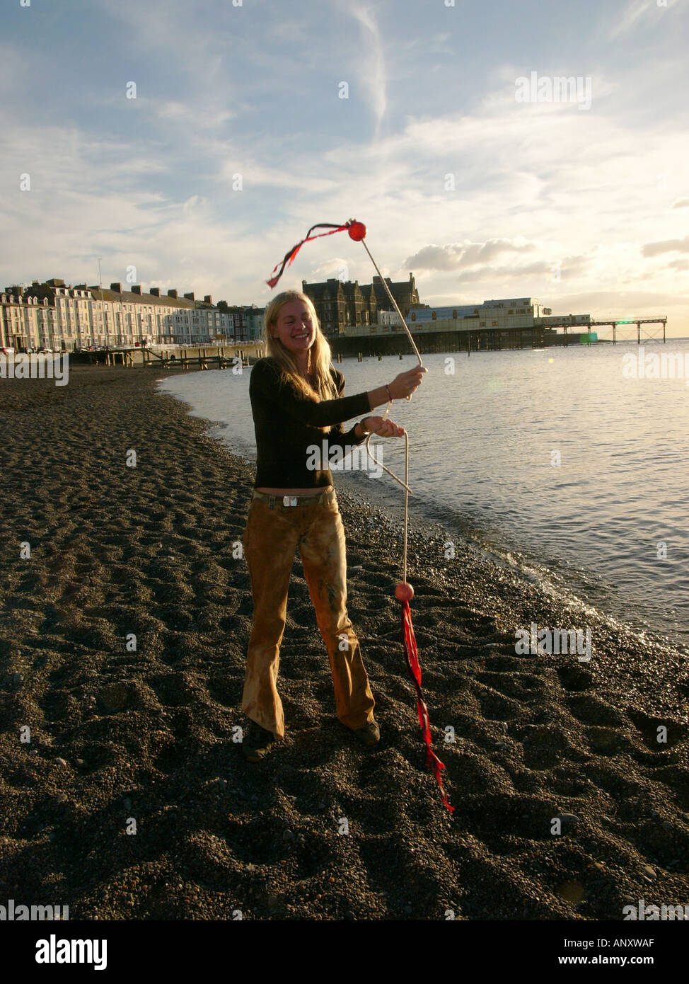 Student Demonstrating Circus Skills on Beach Aberystwyth Ceredigion West Wales Stock Photo