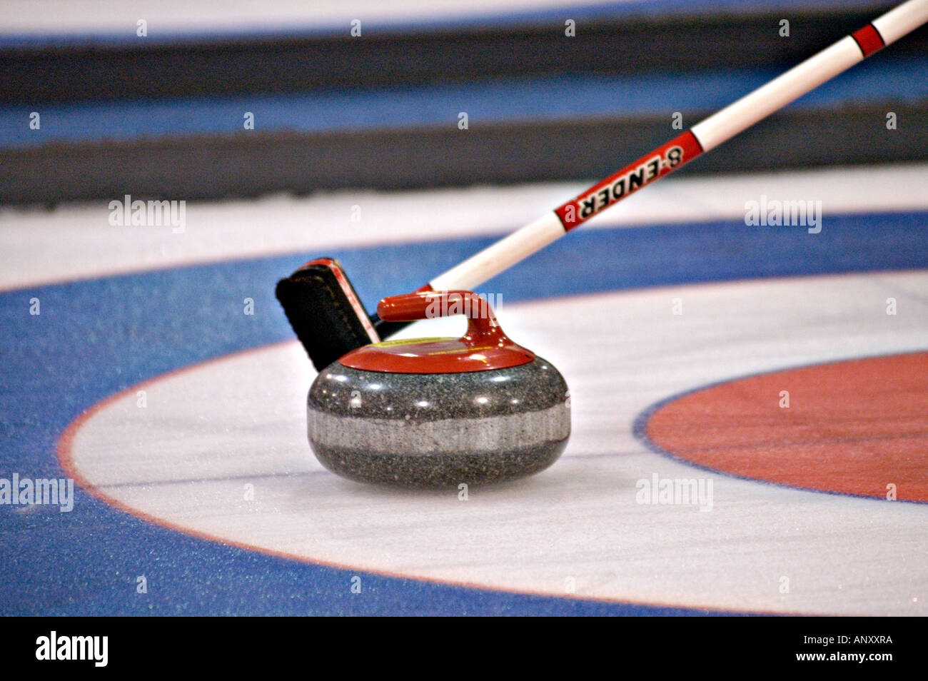 Curling rock and broom Stock Photo Alamy