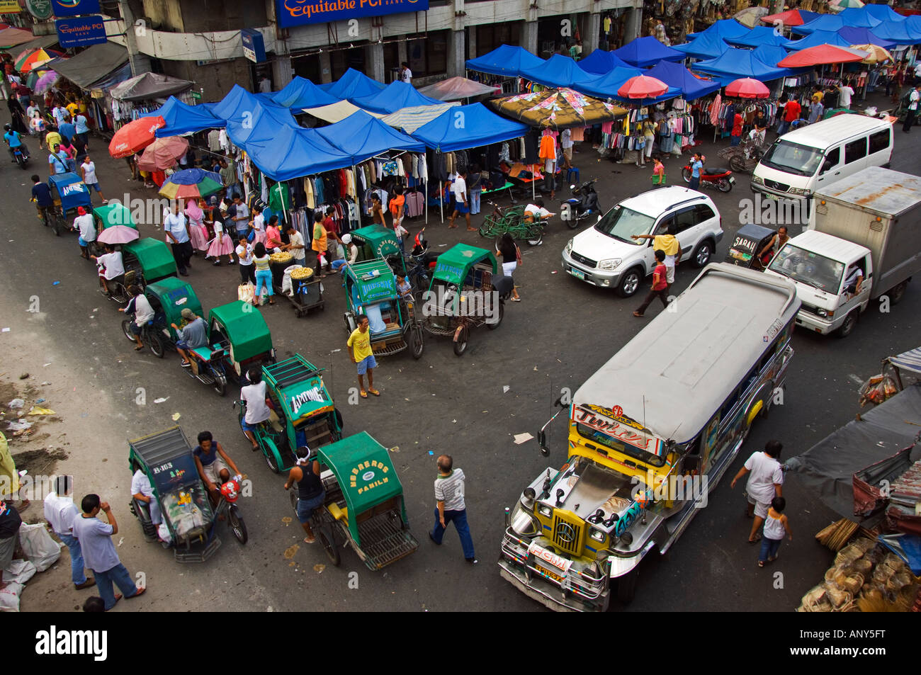 Philippines, Luzon, Manila. Quaipo district a Jeepney and some tricycles at a market Stock