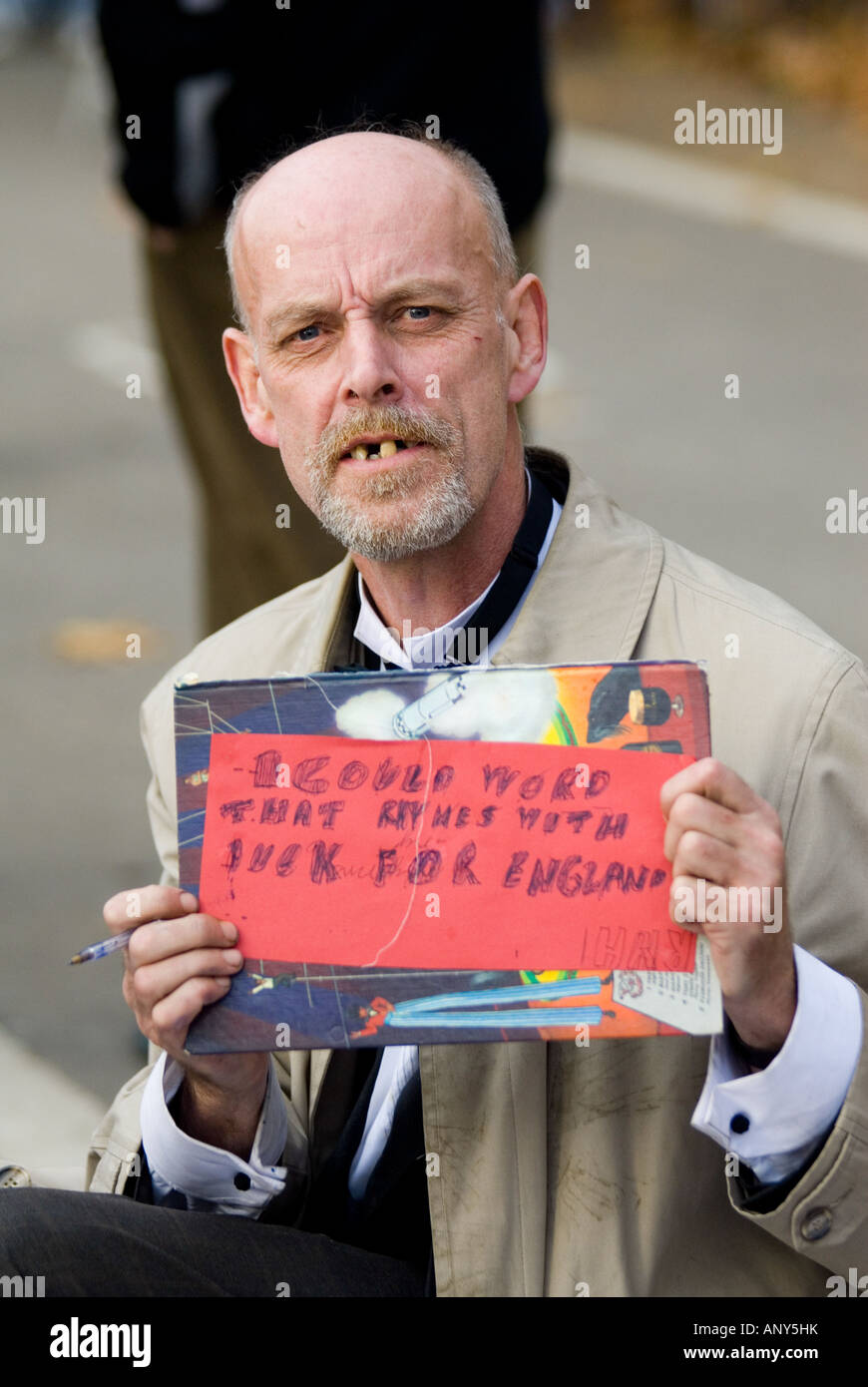 Speakers Corner portrait of a man with a notice in the hand with a few