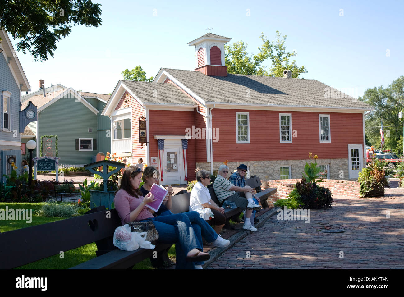 ILLINOIS Long Grove Shoppers sitting on bench in brick plaza shops in