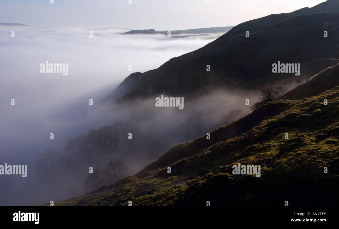 misty morning view over castleton valley in the english peak district