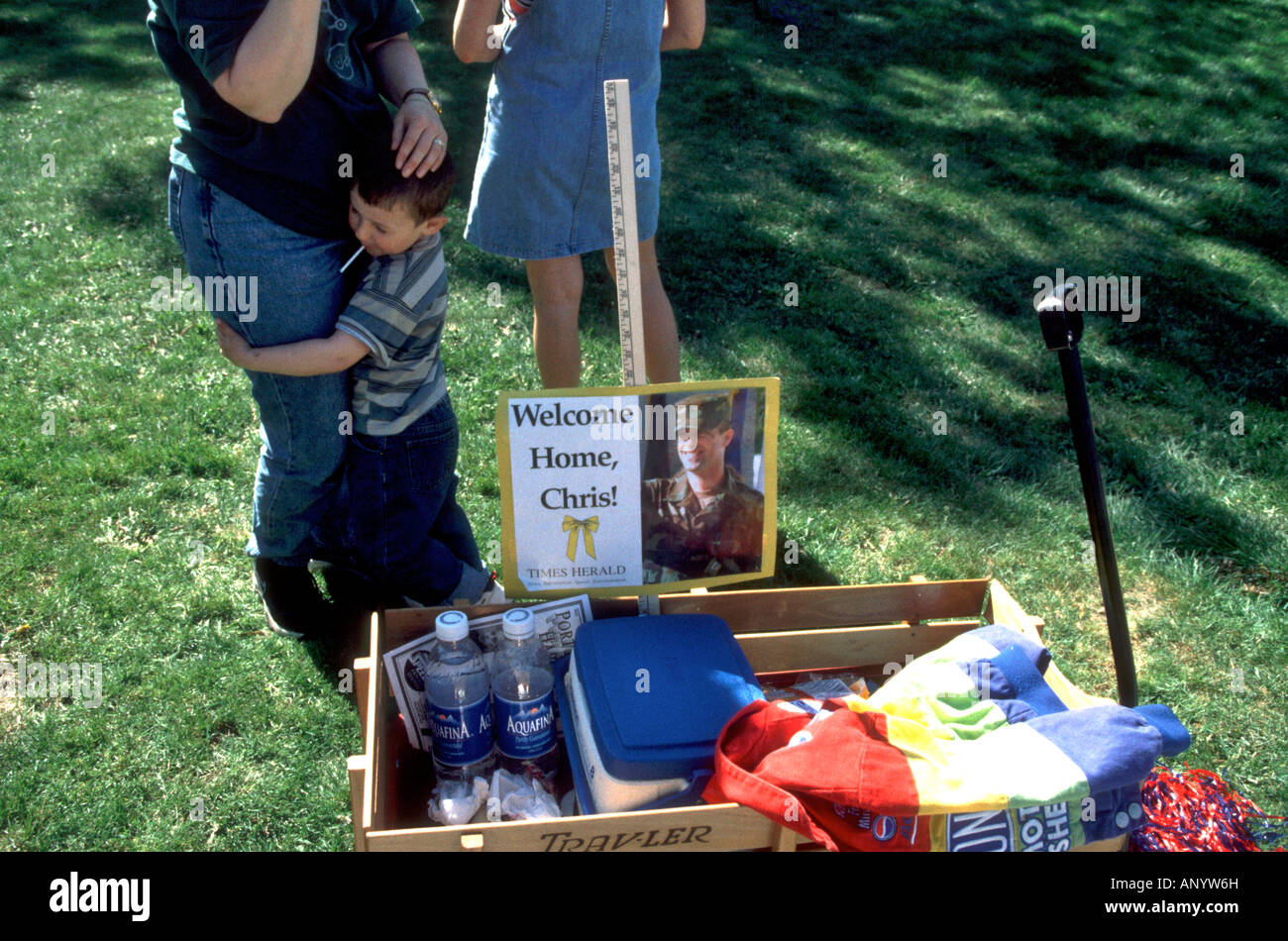 A child hugs his mother during a parade in Capac MI for POW