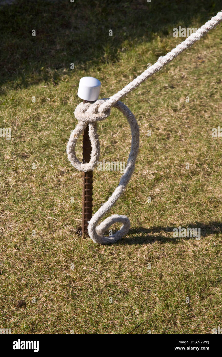 A rope tied to a metal post Stock Photo - Alamy
