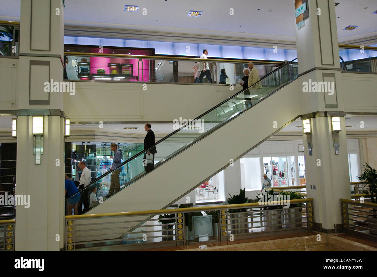 ILLINOIS Chicago People riding escalator in shopping mall 900 North Michigan Avenue on Magnificent Mile Stock Photo