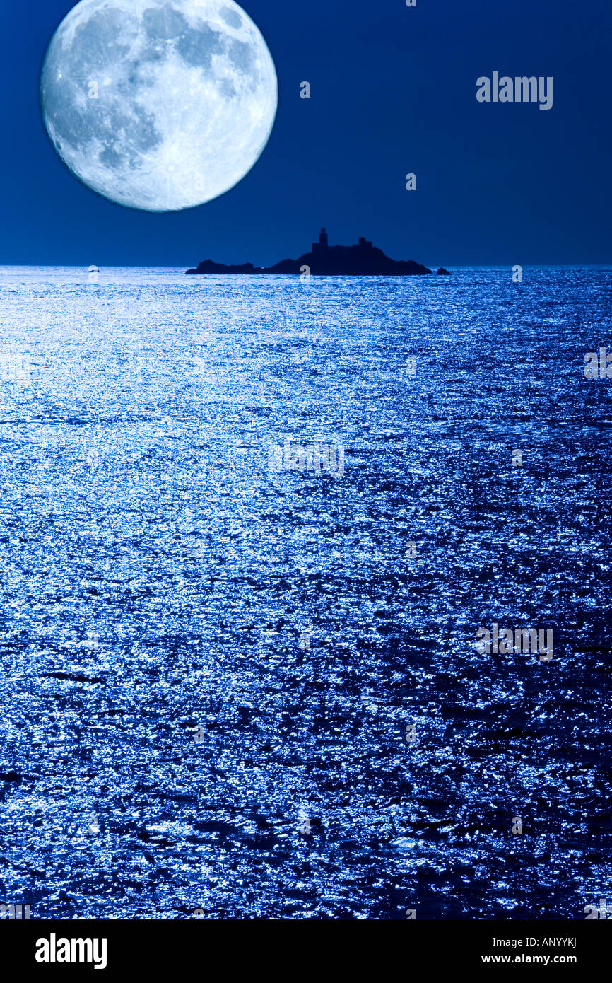 Casquets Lighthouse off Alderney, Channel Islands - the moon was added digitally from a separate image Stock Photo