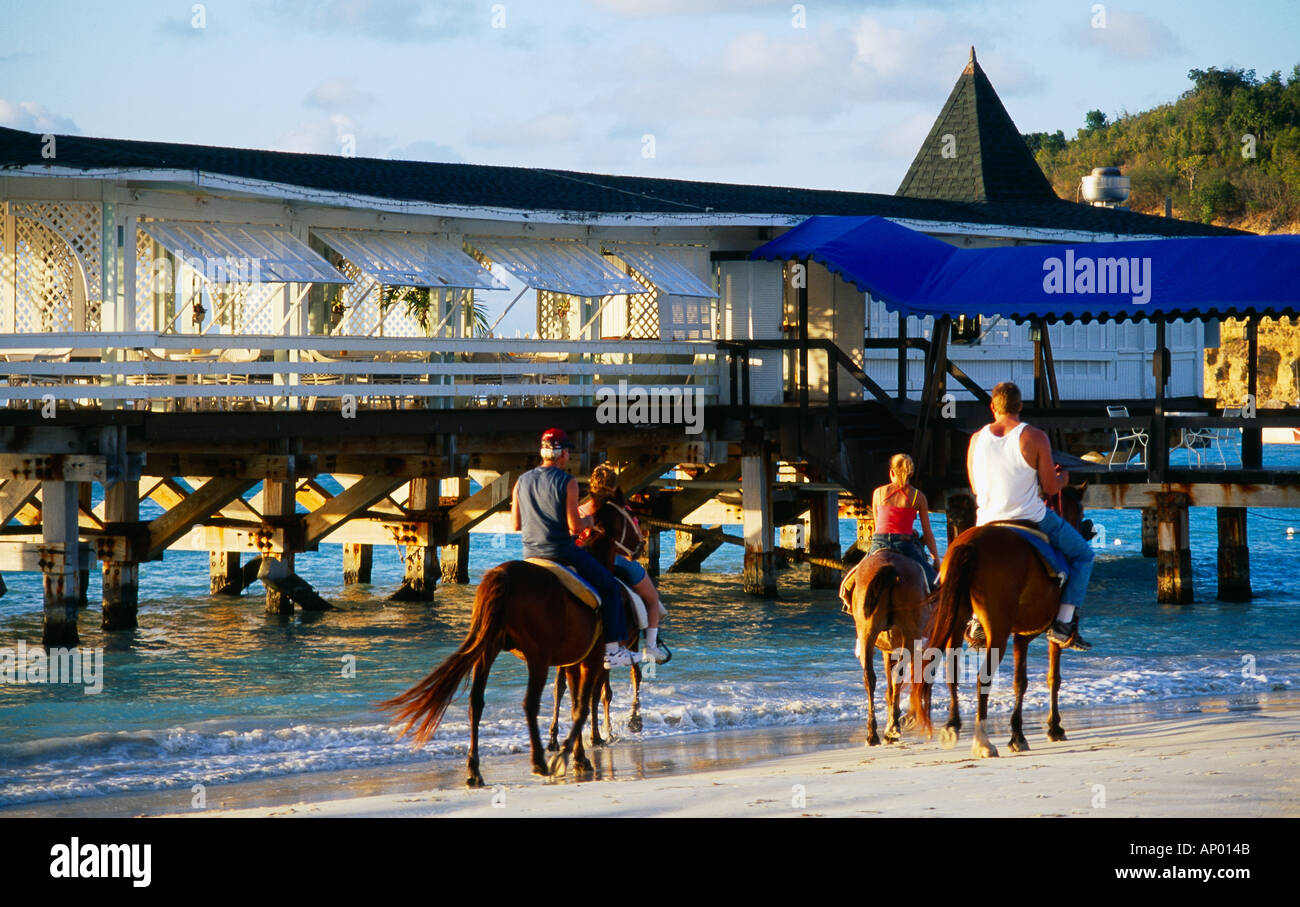 Dickenson Bay Antigua Family Horse riding on Beach Stock Photo
