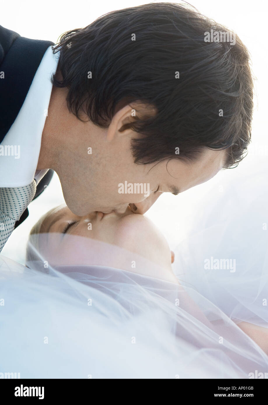 Groom kissing bride Stock Photo - Alamy