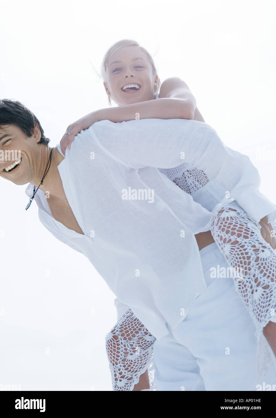 Groom carrying bride piggyback Stock Photo