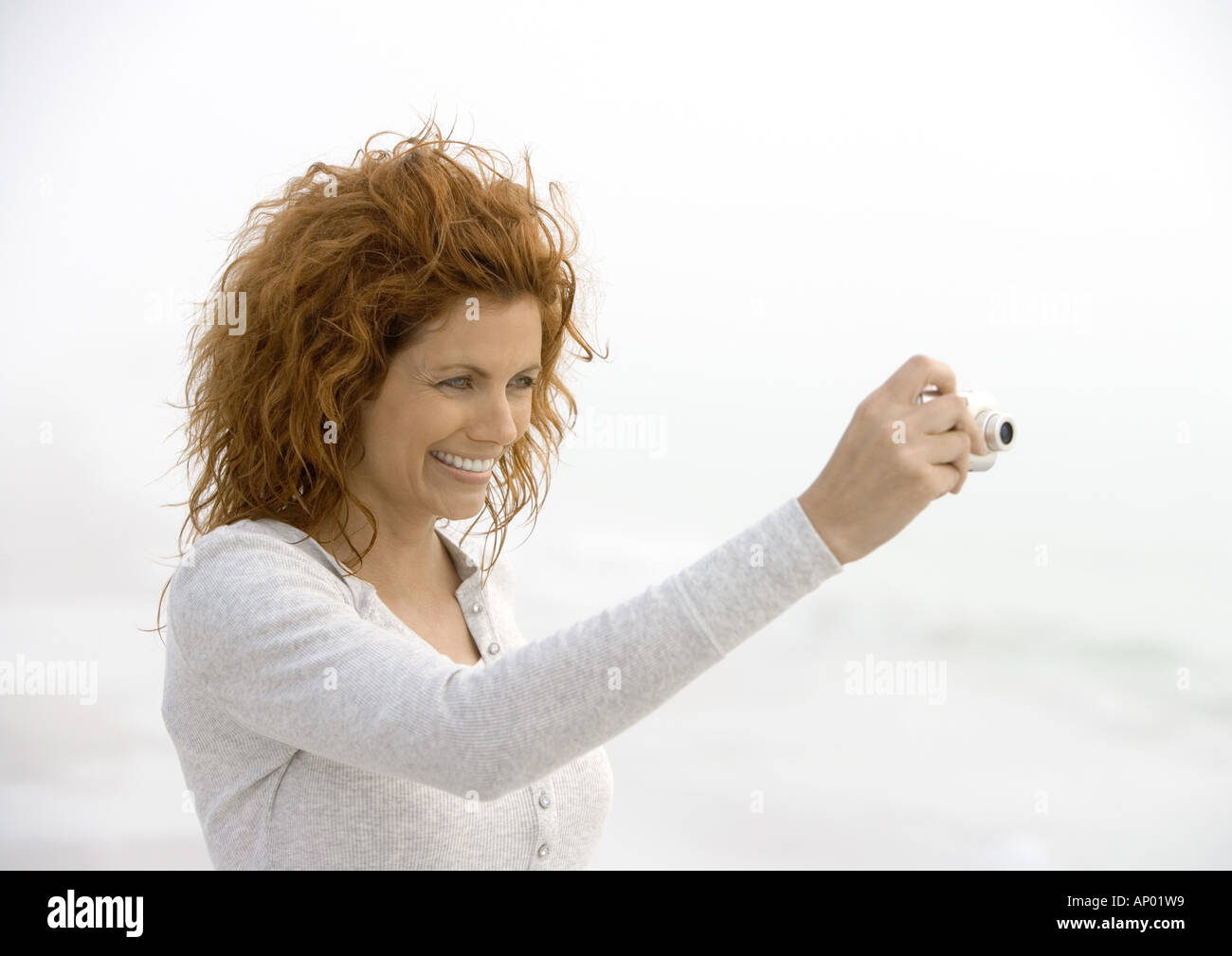 Woman using digital camera Stock Photo