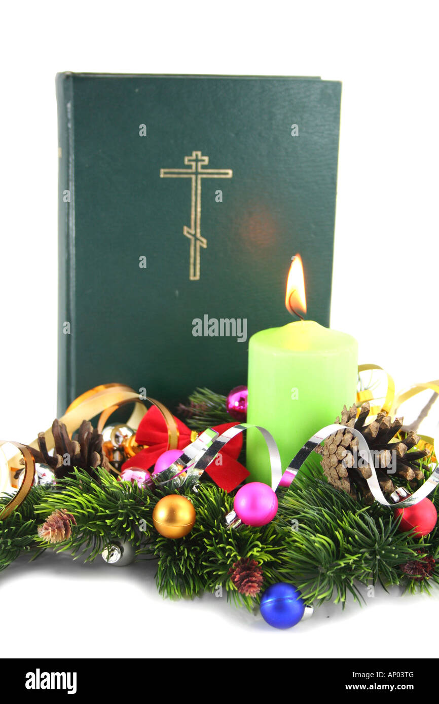 Holy bible on christmas with the conier and candle Stock Photo Alamy
