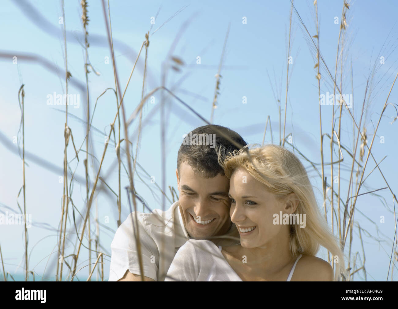 Couple embracing in dune grass Stock Photo