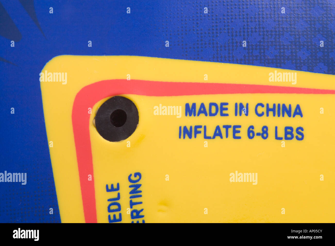 Studio still life Made in China label blue text on yellow background in