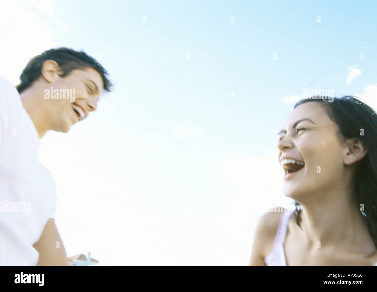 Young couple outdoors, laughing Stock Photo