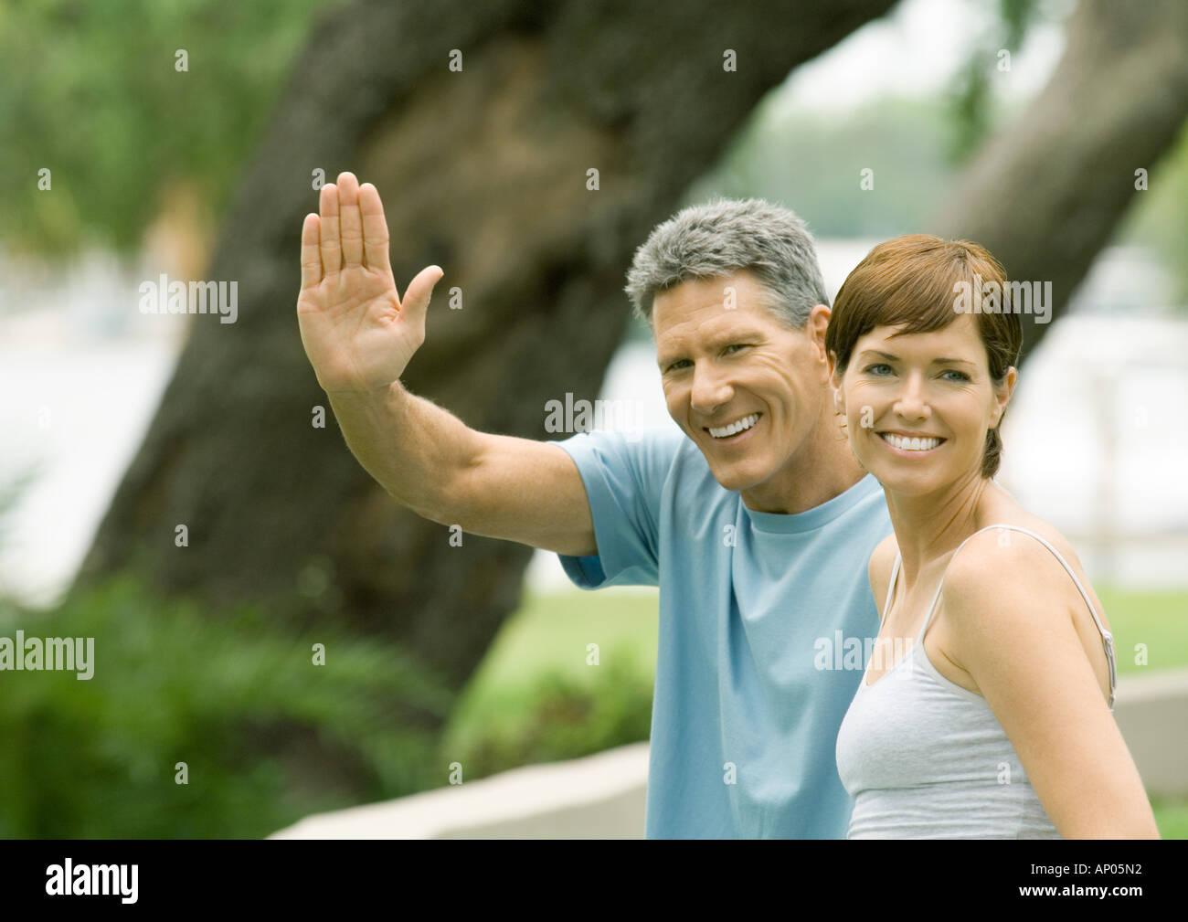 Mature couple, man waving Stock Photo