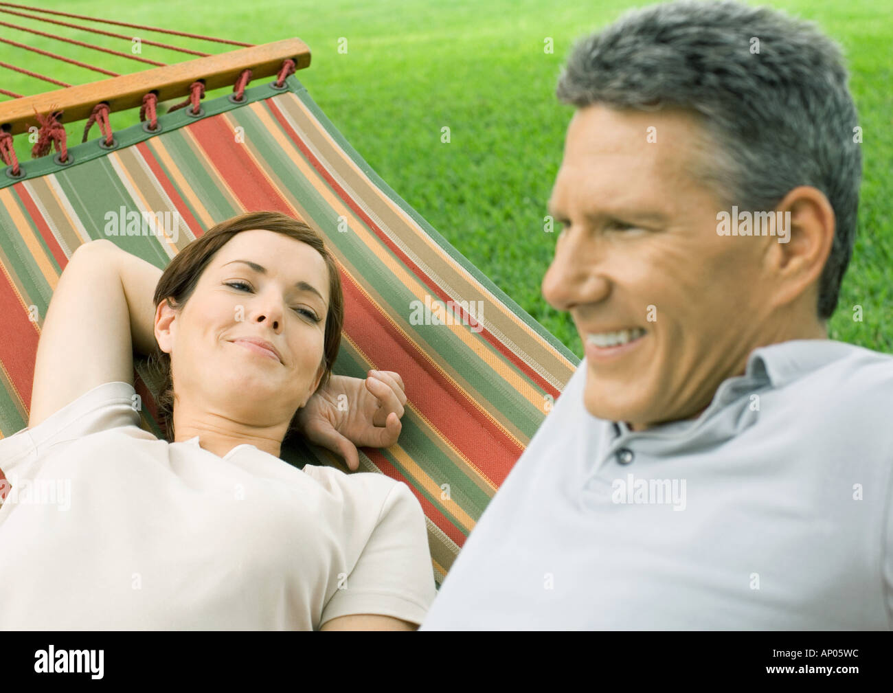 Couple lounging in hammock Stock Photo