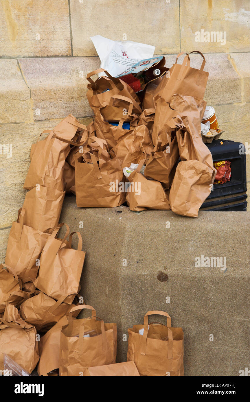 Waste paper bags by rubbish bin Bristol England Stock Photo Alamy