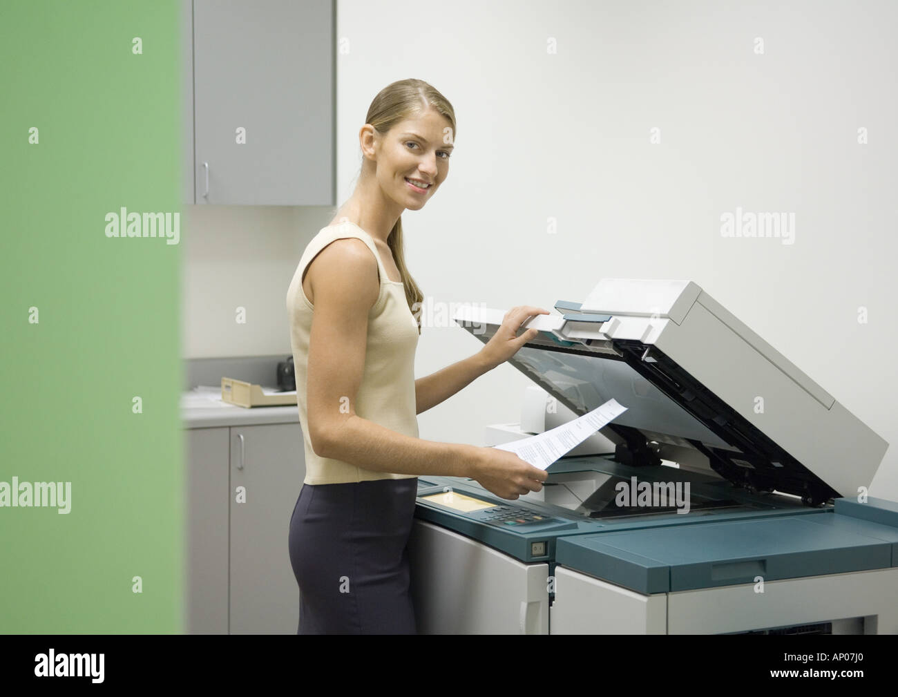 Woman making photocopies in office Stock Photo Alamy